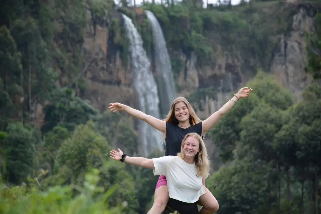 Sipi Falls waterfall on Mount Elgon in eastern Uganda surrounded by lush green hills.