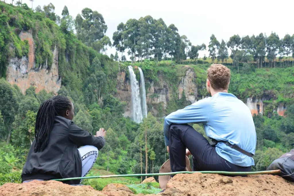 Travelers enjoying a Sipi Falls hiking tour overlooking one of the waterfalls in Eastern Uganda.