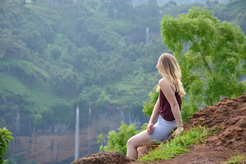Chebonet Waterfalls on Mount Elgon during a guided hiking tour A hiker overlooking the waterfalls and the lush green landscapes of Mount Elgon