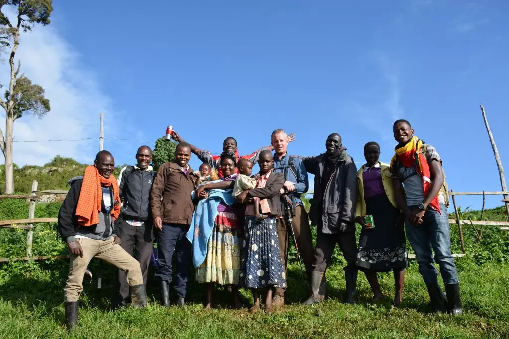 Visitors and Ndorobo community members posing together during a cultural walk on the Ndorobo nature trail near Mount Elgon
