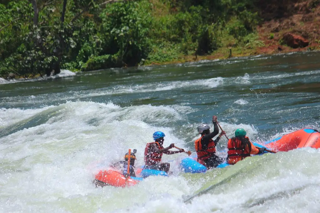 White water rafting on the Nile River in Jinja Uganda adventure tour Jinja adventure experience rafting on River Nile Tourists enjoying white water rafting in Jinja Uganda Nile River rafting with Discover Sipi Falls in Jinja