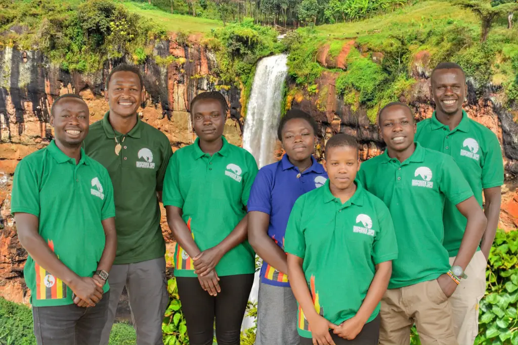 Discover Sipi Falls local guides and office team at Sipi Falls waterfall in Uganda